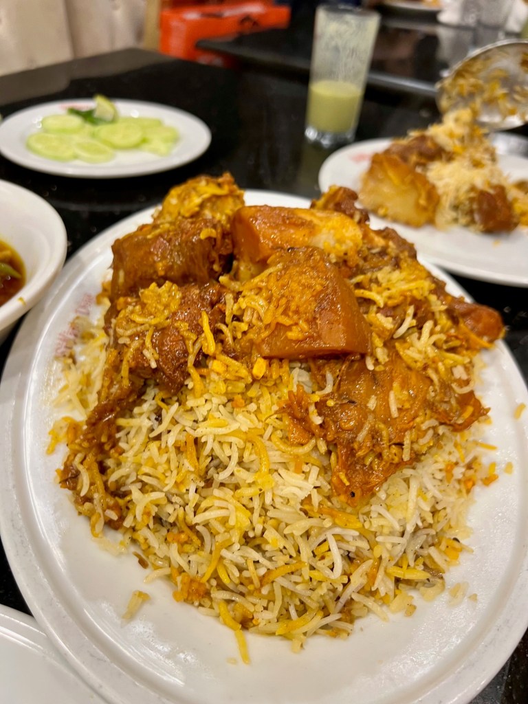 Mutton kacchi biryani served with meat and potatoes piled on top